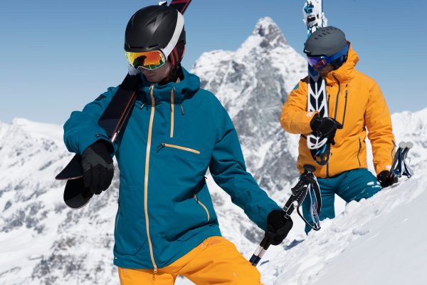 Two men carrying skis in snow, Zermatt, Valais, Switzerland